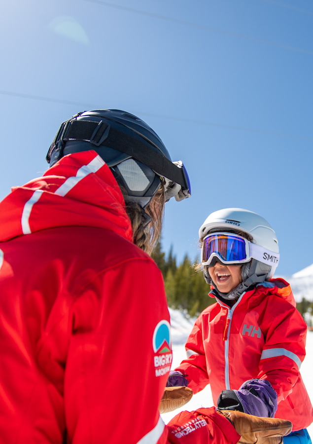 Girl and father in ski gear
